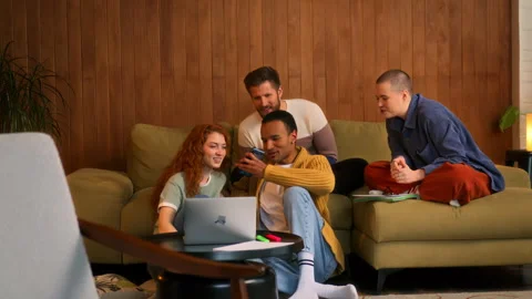 Young multi ethnic friends sit on sofa chatting Stock Footage 268204289