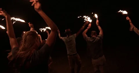 Young multi-ethnic hipster friends celebrating at outdoors party with sparklers Stock Footage
