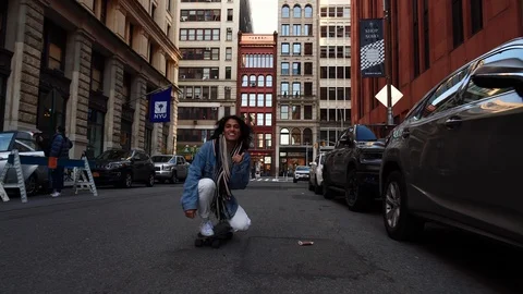 Young multi-ethnic hispanic student girl skateboarding on NYU campus street. Video stock 122531135