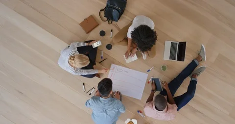 Young multi ethnic marketing team brainstorming business strategy sharing ideas Stock Footage