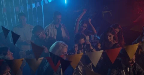 Young multi-ethnic people dancing colorful party in different clothes drinking Video stock 115393129