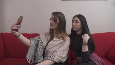 Young multi-ethnic women using smartphone and taking selfies at home Stock Footage 133374676