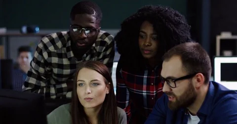 Young multi-ethnical team of office workers having a discussion about a startup Stock Footage 82447557