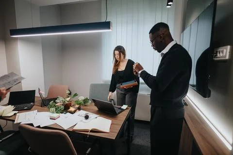 Young multicultural office team collaborating in a modern workspace Stock Photos