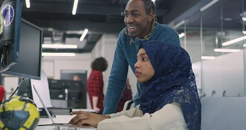 Young multiethnic business team of software developers working together using Stock Footage 113947196