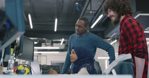 Young multiethnic business team of software developers working together using Stock Footage 113949819