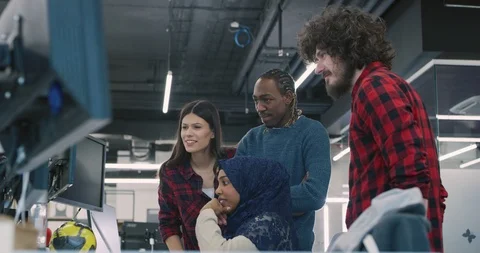 Young multiethnic business team of software developers working together using Stock Footage 113950341