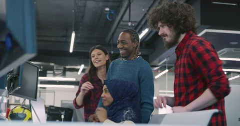 Young multiethnic business team of software developers working together using Stock Footage 113951584