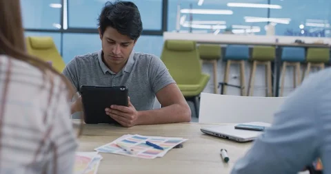 Young multiethnic business team of software developers working together using Stock Footage 113993434