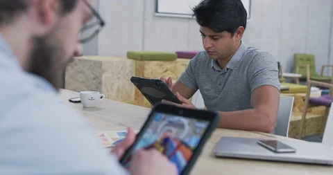 Young multiethnic business team of software developers working together using Stock Footage 113998647