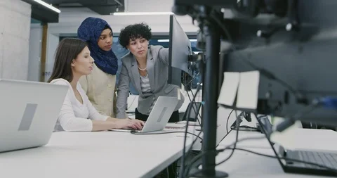 Young multiethnic business team of software developers working together using Stock Footage 114081807