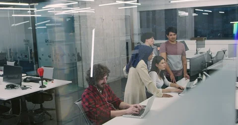 Young multiethnic business team of software developers working together using Stock Footage 114084178