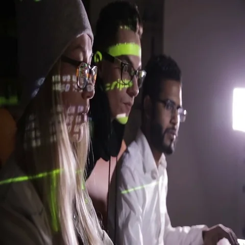 Young multiethnic computer hackers team hacking, trying to gain access to a Stock Footage 69439421