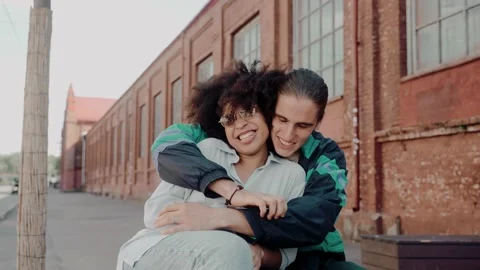 Young multiethnic couple actively talking at the street of old town Video stock 220723339