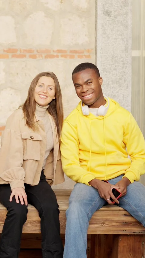 Young multiethnic couple smiling at camera on the street Stock Footage 261428367