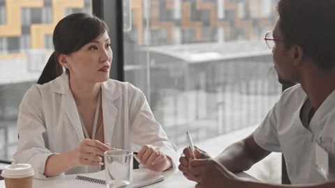 Young Multiethnic Doctors Talking at Meeting Stock Footage 156446643