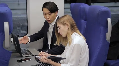 Young multiethnic employees working and speaking in train indoors. Stock Footage 84257109