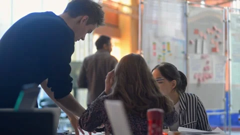 Young multiethnic team is doing research work at table in university campus irrl Stock Footage 135812696