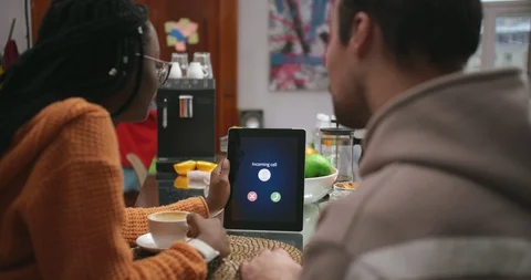 Young multinational couple talking via video link with bank broker Stock Footage 99321301