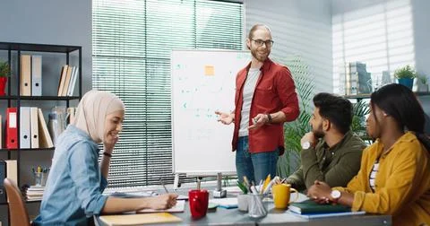 Young multinational group of office workers are brainstorming and looking for Stock Photos