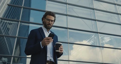 Young Multinational Man Chatting in Glasses working on his Smartphone.  Видео 117692119
