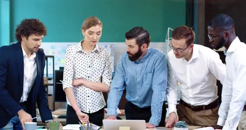 Young multinational team of business analysts brainstorming generates project Stock Footage 140286699