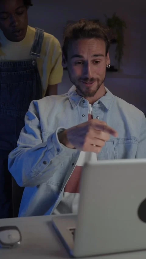 Young multiracial couple affectionate looking sales together on computer in Stock Footage 275157579