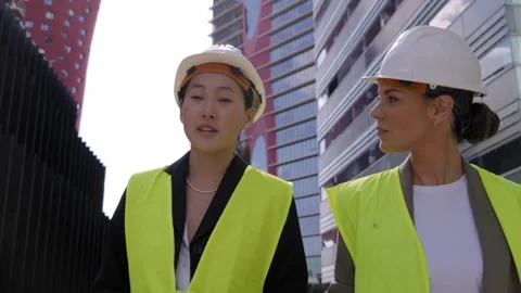 Young multiracial engineering architect couple stroll talking outdoor Stock Footage 261275651