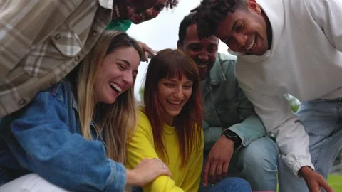 Young multiracial friends having fun looking at mobile phone screen Stock Footage 226693374