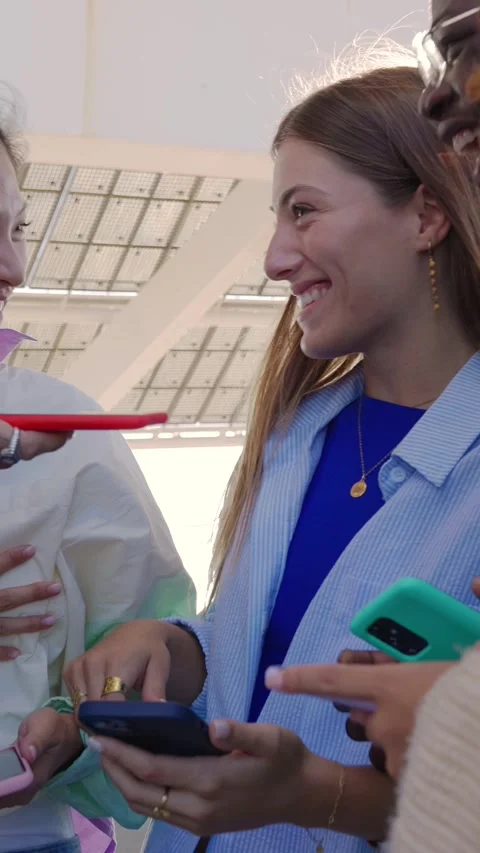 Young multiracial friends having fun looking at mobile phone screen outdoors. Stock Footage 312201286