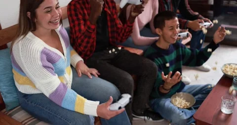 Young multiracial friends playing video games at home Stock Footage 164378902