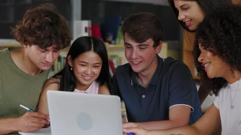 Young multiracial group of high school students working together on laptop Stock Footage 308653357
