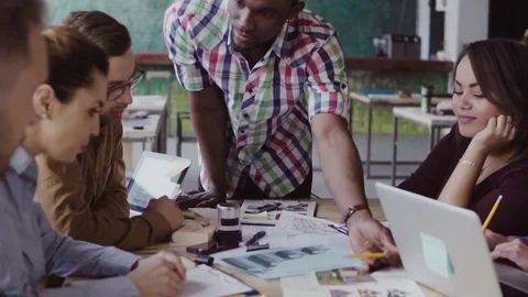 Young multiracial group of people working in coworking space. Small start-up of Stock Footage 84313664