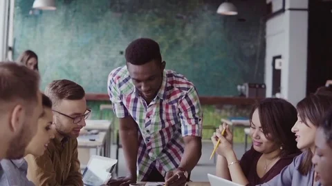 Young multiracial group of people working in coworking space. Small start-up of Stock-Footage 84327950
