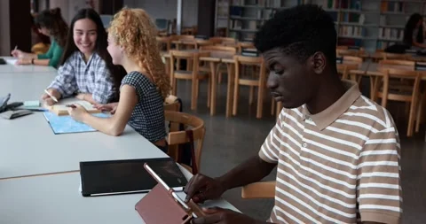 Young multiracial group of students studying inside university library Stock Footage 203721019