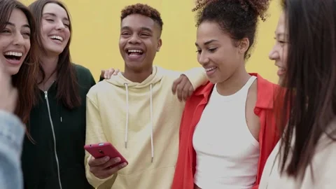 Young multiracial people having fun using social media mobile app outdoors Stock Footage 223762765