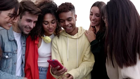 Young multiracial people having fun using social media mobile app Stock Footage 255861928