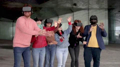 Young multiracial people using virtual reality glasses - Metaverse futuristic Stock Footage 182086845