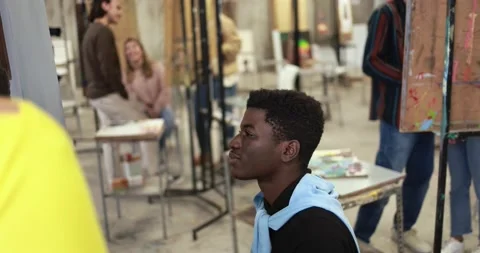 Young multiracial students having fun painting together Stock Footage 168623588