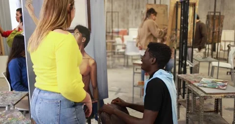 Young multiracial students having fun painting together inside art classroom Video stock 168623593