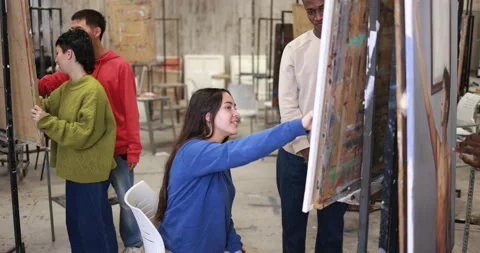 Young multiracial students having fun painting together inside art classroom 스톡 동영상 168623634