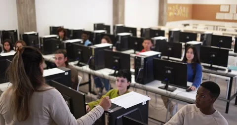 Young multiracial students using computers at school class Stock-Footage 168622489