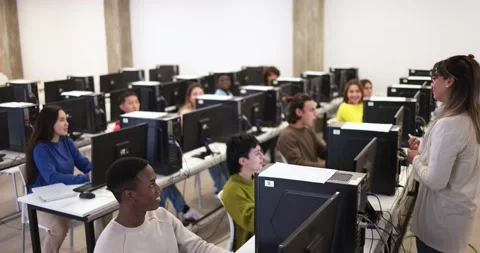 Young multiracial students using computers at school class Видео 168622545