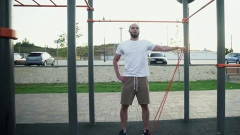 Young muscular man doing exercise to lifting right hand with stretching an Stock Footage 143504066