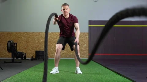 Young muscular man doing heavy rope training at the gym. Stock Footage 101790764