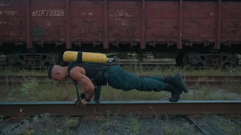 Young muscular man with a drieger balloon on his back is training at the Stock-Footage 218981609