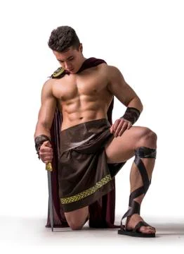 Young muscular man posing in gladiator costume Stock Photos