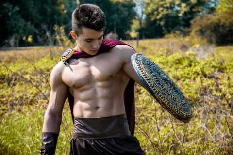 Young muscular man posing in gladiator costume Stock Photos