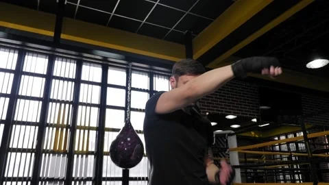Young muscular man practicing punches in the boxing ring. Stock Footage 150266918