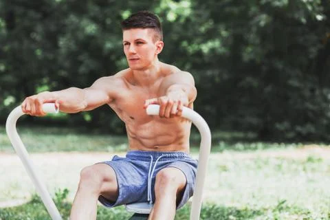 Young muscular man practicing rowing Stock Photos